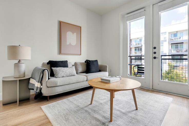 Elegantly designed living room with modern furnishings in an apartment at Troubadour in Austin, Austin