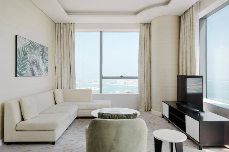 Elegantly designed living room with modern furnishings in an apartment at The Palm Tower in The Palm Jumeirah, Dubai Elegantly designed living room with modern furnishings in an apartment at The Palm Tower in The Palm Jumeirah, Dubai