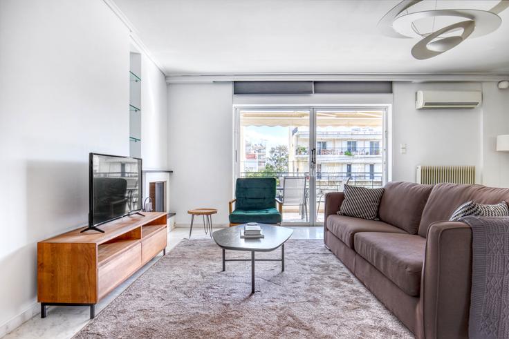 Chic living room with minimalist design from a furnished apartment in Glyfada, Athens