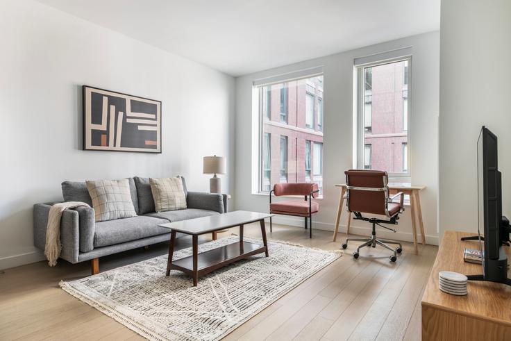 Elegante sala de estar con mobiliario moderno en un apartamento en The Harris en Boston, Boston Elegante sala de estar con mobiliario moderno en un apartamento en The Harris en Boston, Boston