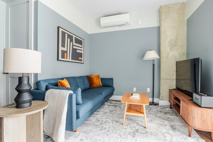 Elegante sala de estar con mobiliario moderno en un apartamento en The Kent House en Brooklyn, New York Elegante sala de estar con mobiliario moderno en un apartamento en The Kent House en Brooklyn, New York