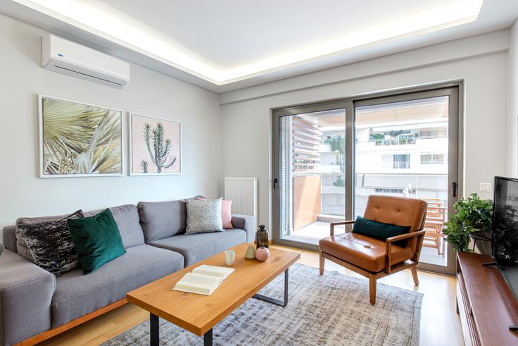 Elegantly designed living room with modern furnishings in an apartment at 823215c4-a862-4445-bf38-d59996dff334 in Glyfada, Athens