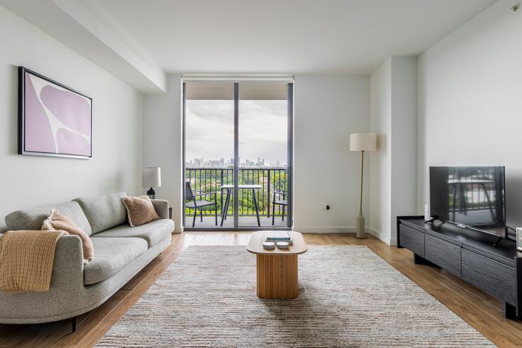 Elegantly designed living room with modern furnishings in an apartment at Blume Coral Gables in Miami, Miami