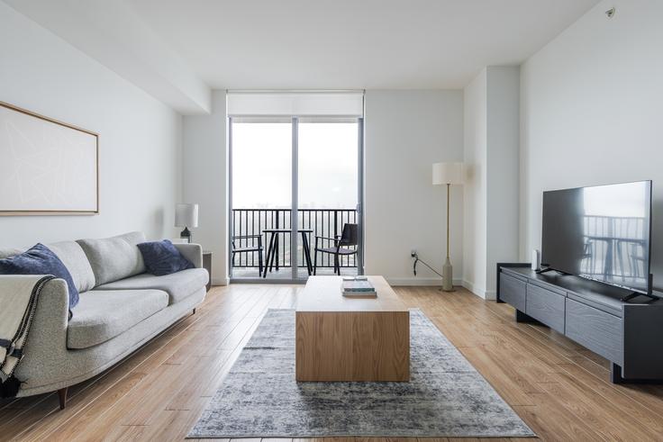 Elegantly designed living room with modern furnishings in an apartment at Blume Coral Gables in Miami, Miami