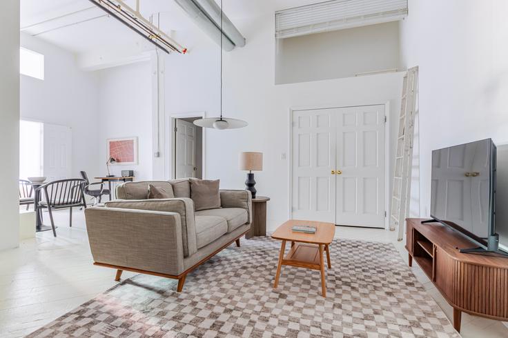 Elegantly designed living room with modern furnishings in an apartment at 57 Jay in Brooklyn, New York