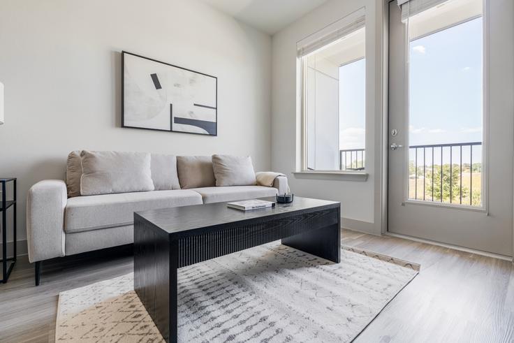Elegantly designed living room with modern furnishings in an apartment at Del Via in Austin, Austin
