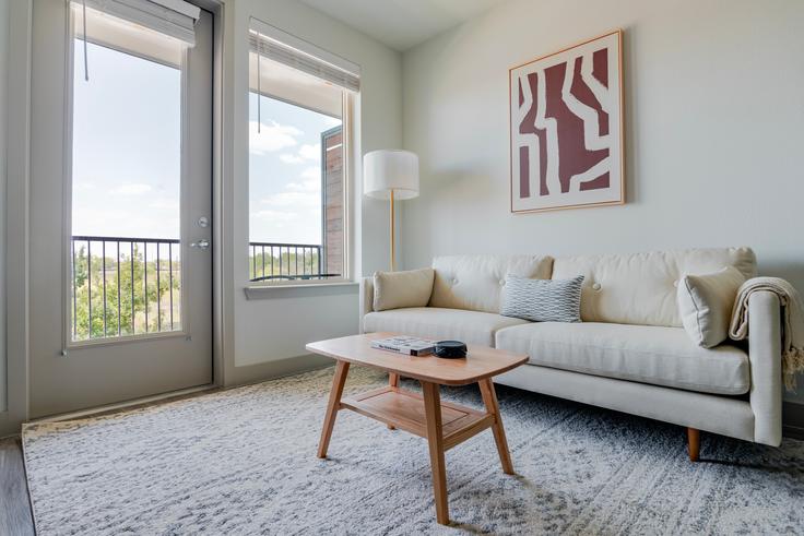 Elegantly designed living room with modern furnishings in an apartment at Del Via in Austin, Austin