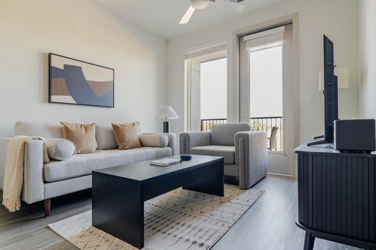 Elegantly designed living room with modern furnishings in an apartment at Del Via in Austin, Austin Elegantly designed living room with modern furnishings in an apartment at Del Via in Austin, Austin
