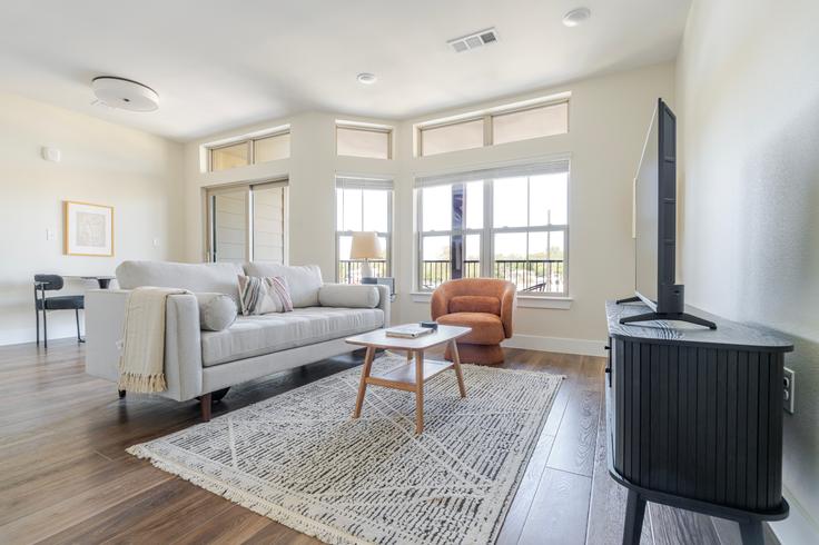 Elegantly designed living room with modern furnishings in an apartment at The Kelsey in Austin, Austin Elegantly designed living room with modern furnishings in an apartment at The Kelsey in Austin, Austin