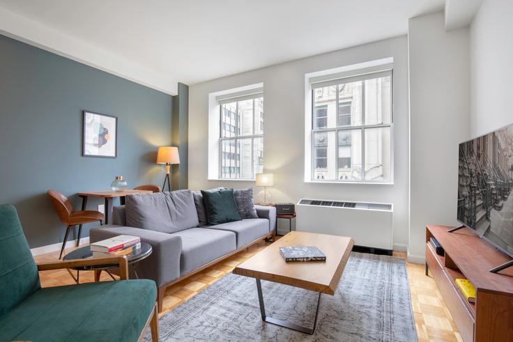 Elegantly designed living room with modern furnishings in an apartment at 63 Wall Street in Financial District, New York