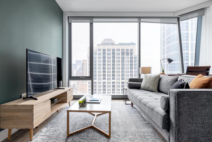 Elegantly designed living room with modern furnishings in an apartment at Arrive Michigan Avenue in South Loop, Chicago