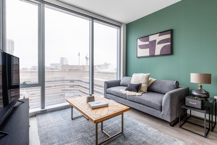 Elegantly designed living room with modern furnishings in an apartment at Hub50House in North Station, Boston