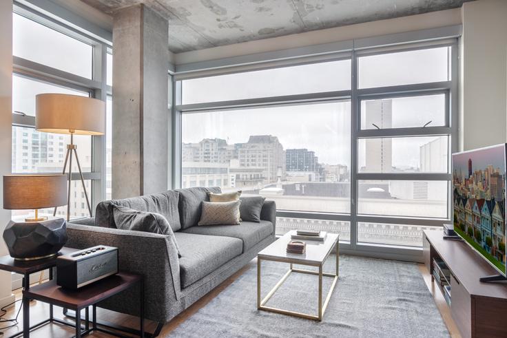 Elegantly designed living room with modern furnishings in an apartment at Etta in Nob Hill, San Francisco Bay Area