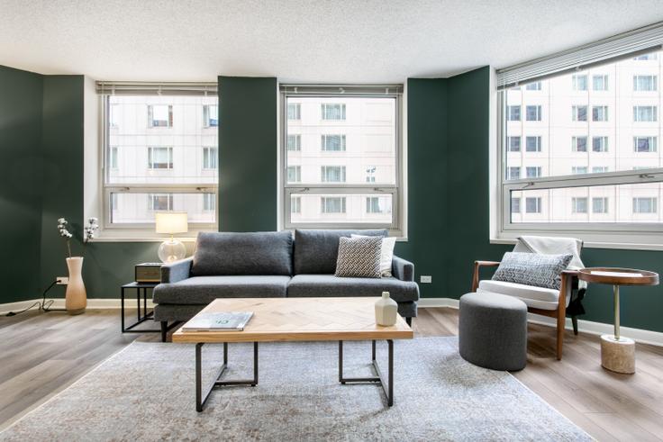 Elegantly designed living room with modern furnishings in an apartment at The Chicagoan in River North, Chicago