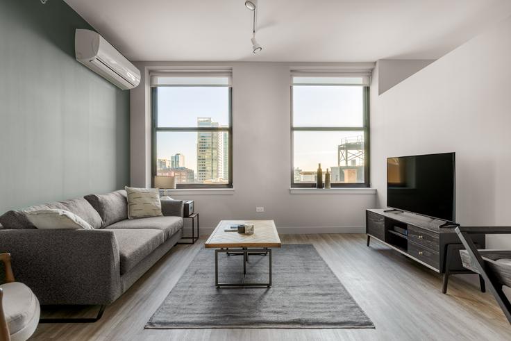 Elegantly designed living room with modern furnishings in an apartment at 330 S Wells in The Loop, Chicago