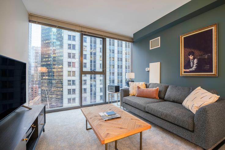 Elegantly designed living room with modern furnishings in an apartment at Lake & Wells Apartments in The Loop, Chicago