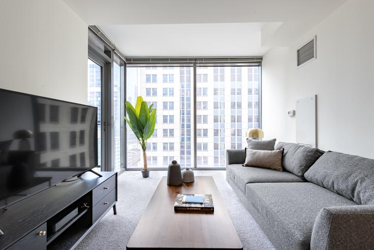 Elegantly designed living room with modern furnishings in an apartment at Lake & Wells Apartments in The Loop, Chicago