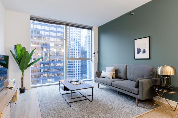 Elegantly designed living room with modern furnishings in an apartment at Mila in The Loop, Chicago