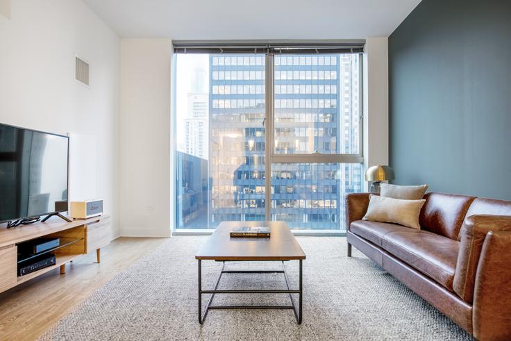 Elegantly designed living room with modern furnishings in an apartment at Mila in The Loop, Chicago