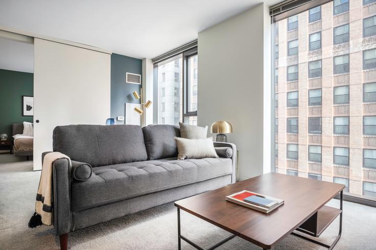 Elegantly designed living room with modern furnishings in an apartment at Lake & Wells Apartments in The Loop, Chicago