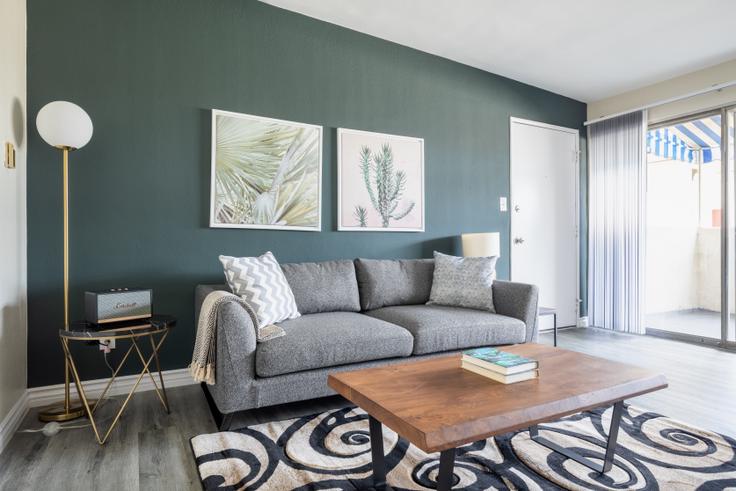 Elegantly designed living room with modern furnishings in an apartment at 3537 Clarington Ave in Culver City, Los Angeles