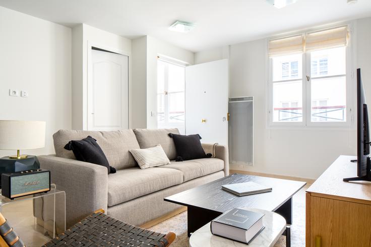 Elegantly designed living room with modern furnishings in an apartment at Tronchet 23 in Madeleine, Paris