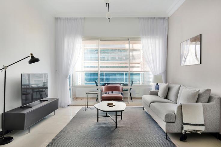Elegantly designed living room with modern furnishings in an apartment at O2 Residences in JLT, Dubai