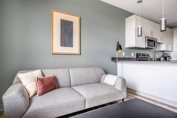 Elegantly designed living room with modern furnishings in an apartment at The Overlook at St. Gabriel's - 161 Washington in Brighton, Boston