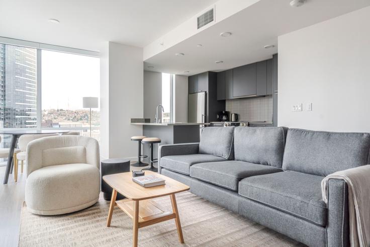 Elegantly designed living room with modern furnishings in an apartment at The Ivey on Boren in Seattle, Seattle
