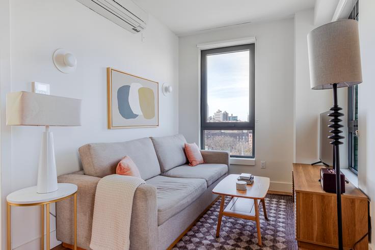 Elegantly designed living room with modern furnishings in an apartment at Casa Hope in Brooklyn, New York Elegantly designed living room with modern furnishings in an apartment at Casa Hope in Brooklyn, New York