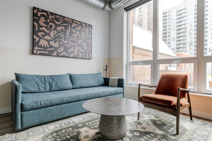 Elegantly designed living room with modern furnishings in an apartment at The Opal in Chicago, Chicago