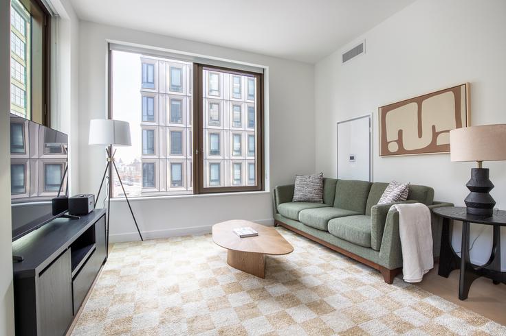 Elegantly designed living room with modern furnishings in an apartment at Four Williamsburg Wharf in Brooklyn, Brooklyn