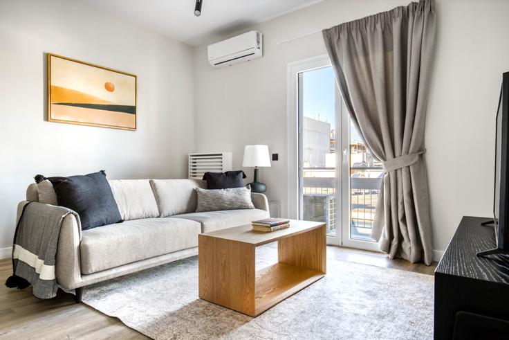 Elegantly designed living room with modern furnishings in an apartment at d48f984a-83cf-4f87-af8e-3f3fac28029b in Cholargos, Athens