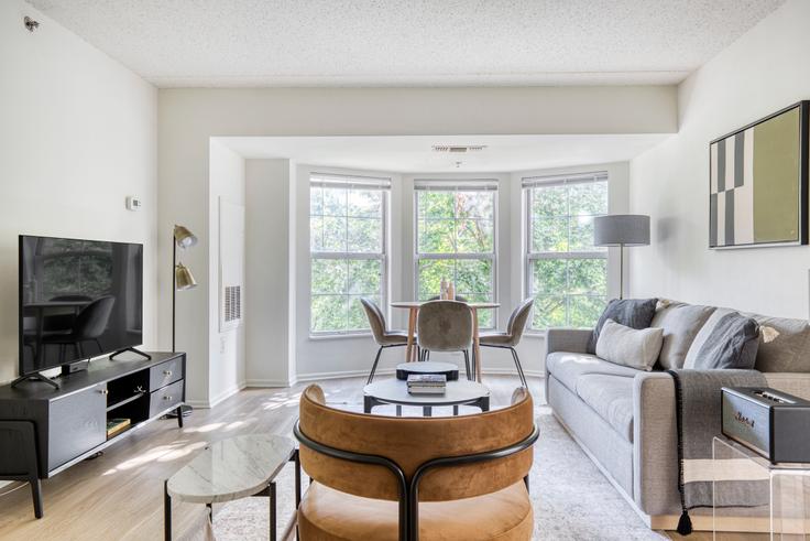 Elegantly designed living room with modern furnishings in an apartment at Avalon Cove in Jersey City, New York