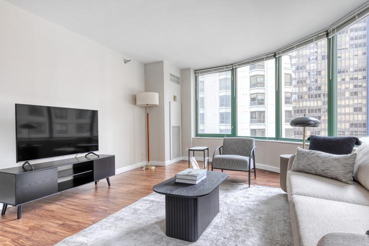 Elegantly designed living room with modern furnishings in an apartment at 420 East Ohio in Streeterville, Chicago