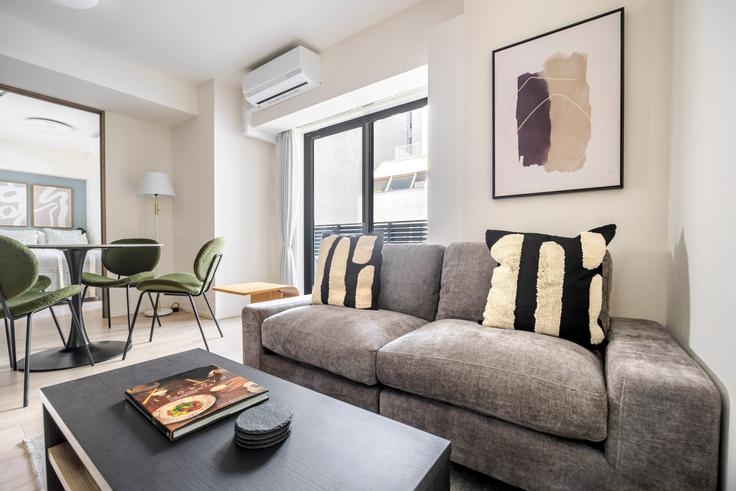 Elegantly designed living room with modern furnishings in an apartment at Live Casa Ochanomizu in Bunkyo City, Tokyo Elegantly designed living room with modern furnishings in an apartment at Live Casa Ochanomizu in Bunkyo City, Tokyo