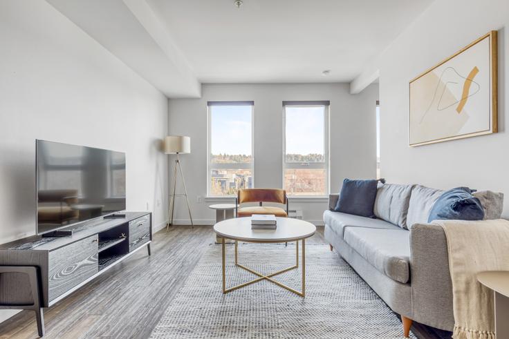 Elegantly designed living room with modern furnishings in an apartment at AVA Ballard in Ballard, Seattle