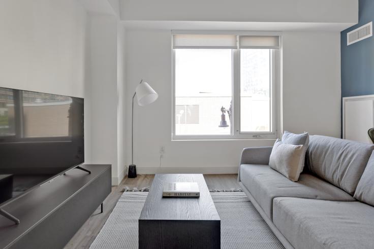 Elegantly designed living room with modern furnishings in an apartment at The Harlo in Fenway, Boston