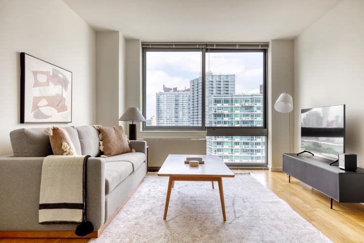 Elegantly designed living room with modern furnishings in an apartment at Avalon Riverview North in Long Island City, New York