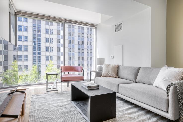 Elegantly designed living room with modern furnishings in an apartment at Lake & Wells Apartments in The Loop, Chicago