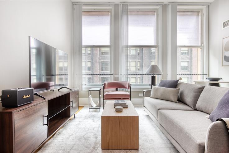 Elegantly designed living room with modern furnishings in an apartment at Fisher Club in The Loop, Chicago