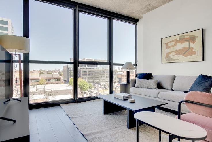 Elegantly designed living room with modern furnishings in an apartment at The Mason in West Loop, Chicago