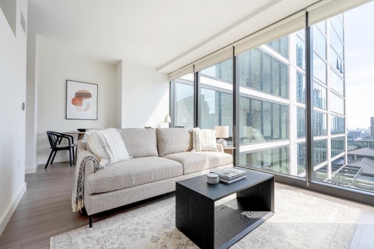 Elegantly designed living room with modern furnishings in an apartment at NEMA in South Loop, Chicago