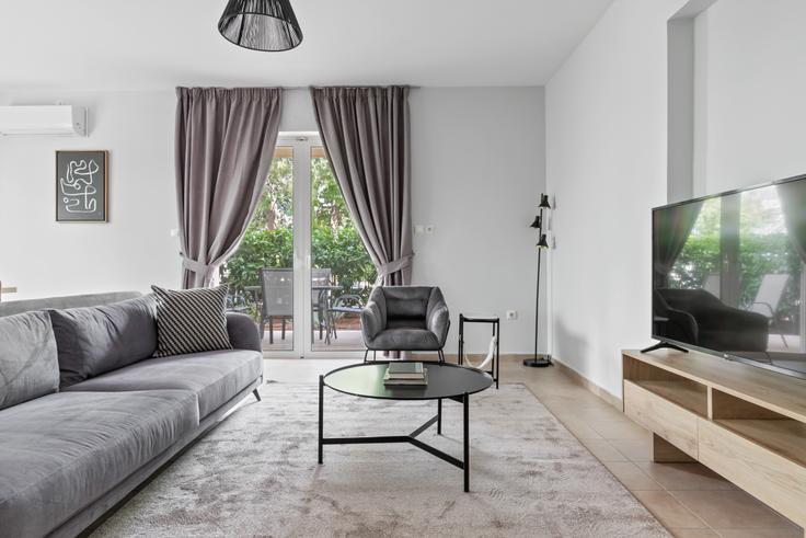 Elegantly designed living room with modern furnishings in an apartment at 1a1fa662-dd3e-4583-ab82-8dc6f9975afc in Melissia, Athens