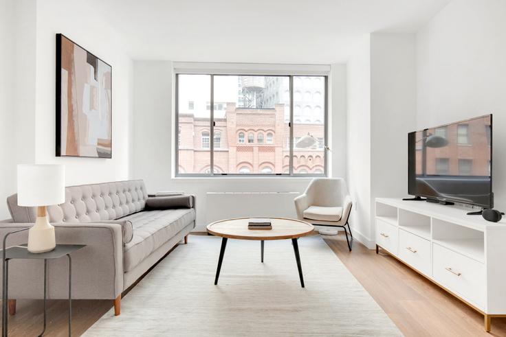 Elegantly designed living room with modern furnishings in an apartment at 15 Cliff in Financial District, New York