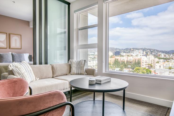 Elegantly designed living room with modern furnishings in an apartment at AVA Hollywood in Hollywood, Los Angeles