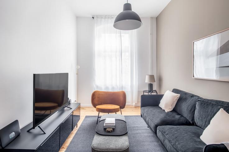 Elegantly designed living room with modern furnishings in an apartment at Eylauer in Kreuzberg, Berlin