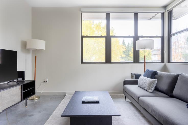 Elegantly designed living room with modern furnishings in an apartment at E3 Edge in Allston, Boston