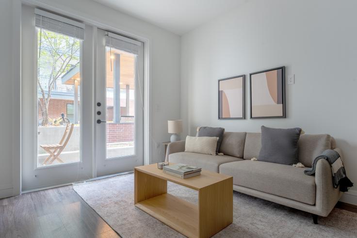 Elegantly designed living room with modern furnishings in an apartment at Troubadour in Central, Austin