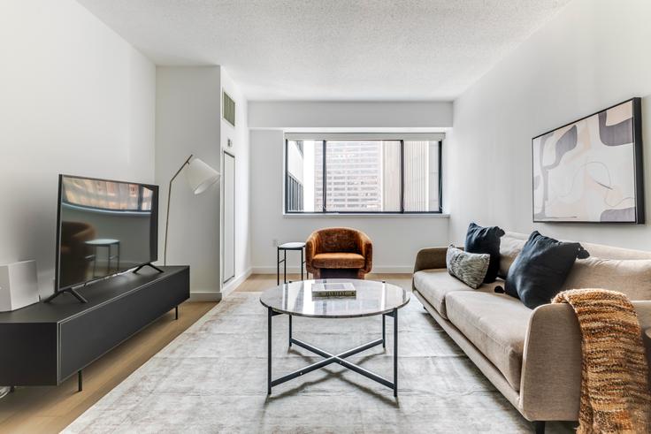 Salle de séjour élégante avec mobilier moderne dans un appartement à Devonshire à Boston, Boston Salle de séjour élégante avec mobilier moderne dans un appartement à Devonshire à Boston, Boston
